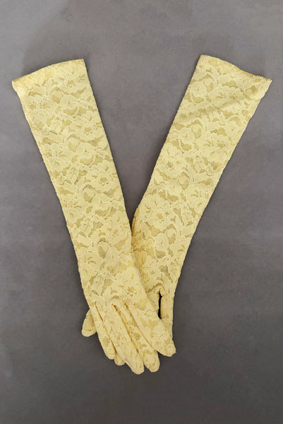 Vertical pair view of 1960s vintage below elbow yellow stretch lace gloves.