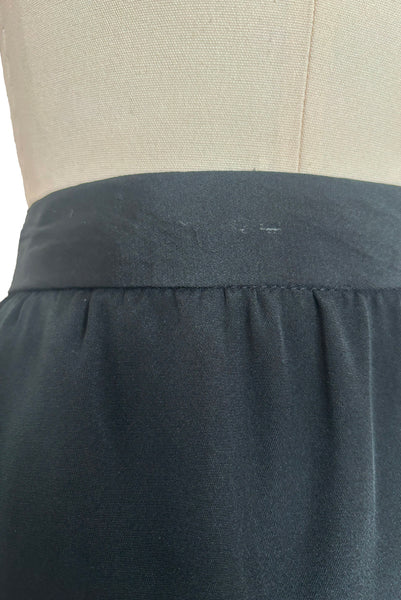 Detail view of 1990s vintage black silk maxi evening skirt with train by Fernando Pena, size extra small to small. Showing the waistband with a mark on the silk from a clip hanger.