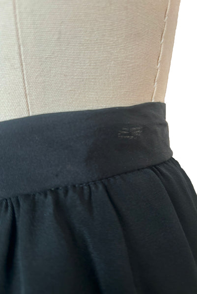 Detail view of 1990s vintage black silk maxi evening skirt with train by Fernando Pena, size extra small to small. Showing the waistband with a mark on the silk from a clip hanger.