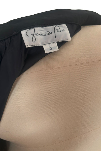 Interior detail view of 1990s vintage black silk maxi evening skirt with train by Fernando Pena, size extra small to small. Showing the Fernando Pena label and size 4 tag.