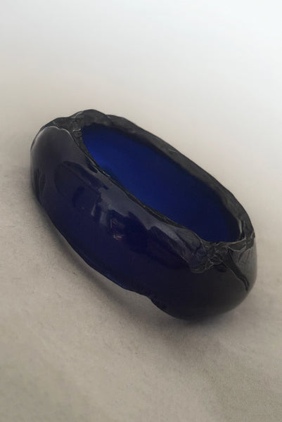 Vertical perspective view of 1980s vintage artisan carved translucent blue Lucite asymmetrical bangle bracelet.