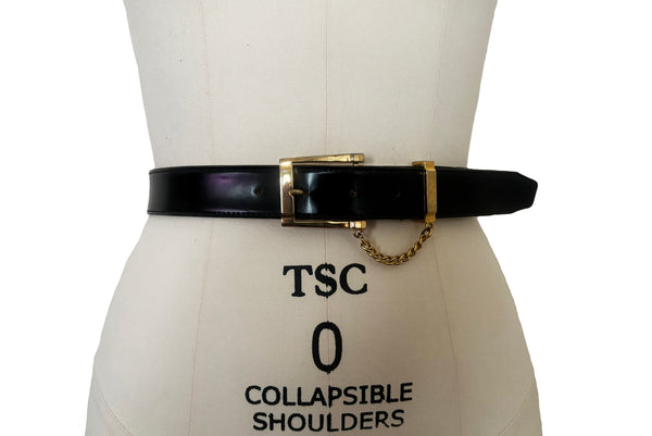 Front view of 1990s vintage black leather and gold chain buckle designer belt by Ellen Tracy, size extra small to small.