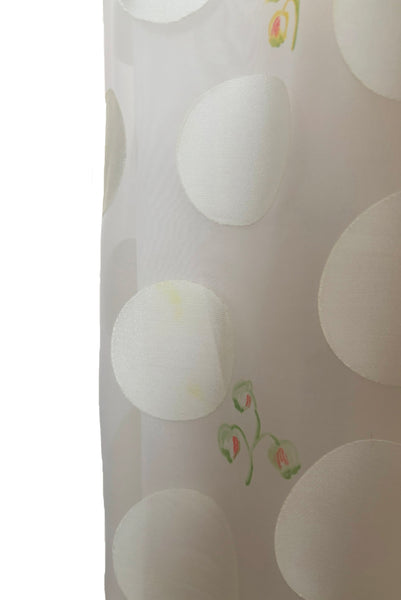 Detail view of 1960s vintage white chiffon, satin polka dot, yellow and green lily of the valley print floral maxi dress by Richilene New York for Neiman Marcus, size small to medium. Showing a small misprint of the yellow ink on the gathered skirt.