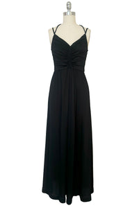 Front view of vintage 1970s black knit strappy maxi dress, extra small to small. Showing the multiple straps, gathered sweetheart bodice, and floor length skirt with center front slit.