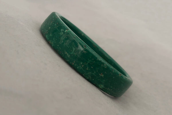 Horizontal perspective view of 1960s vintage green and white mottled textured two (2) sliced bangle bracelet set. Showing a single bangle.