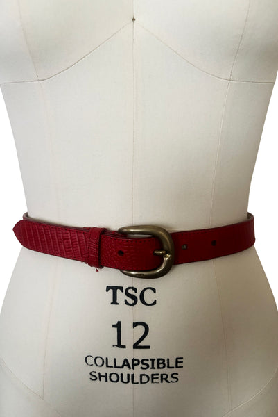 Front view of 1980s vintage designer red stamped Italian leather belt  with brass buckle by Furla, size medium to large. Made in Italy.