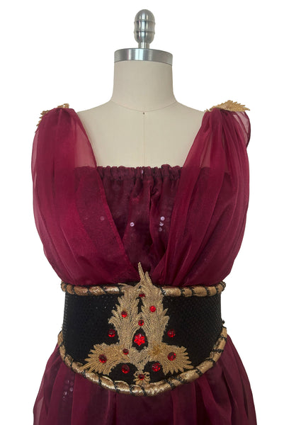 Bodice front view of 1990s vintage burgundy organza and black sequin Grecian fantasy gown costume, medium to large. Showing the gathered shoulders and wide black and gold belt with red rhinestones.