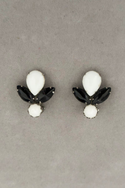 Vertical front view of 1960s vintage pear, marquise, and round cabochon black, white, and silver tone unpierced clip-on earrings by Weiss.