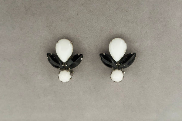 Horizontal front view of 1960s vintage pear, marquise, and round cabochon black, white, and silver tone unpierced clip-on earrings by Weiss.