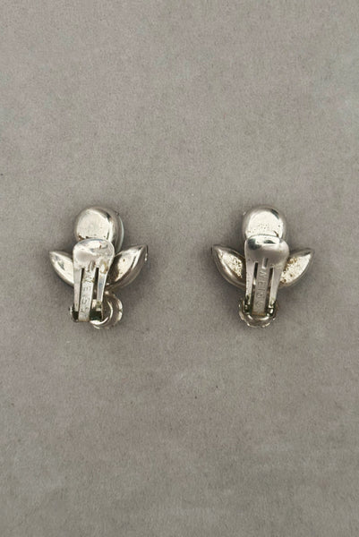 Vertical back view of 1960s vintage pear, marquise, and round cabochon black, white, and silver tone unpierced clip-on earrings by Weiss.