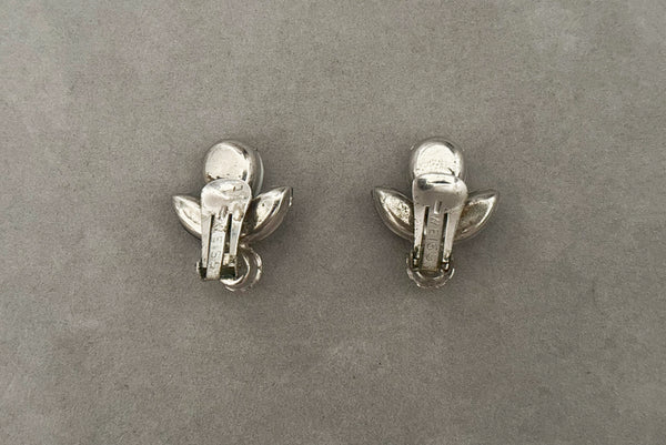 Horizontal back view of 1960s vintage pear, marquise, and round cabochon black, white, and silver tone unpierced clip-on earrings by Weiss.