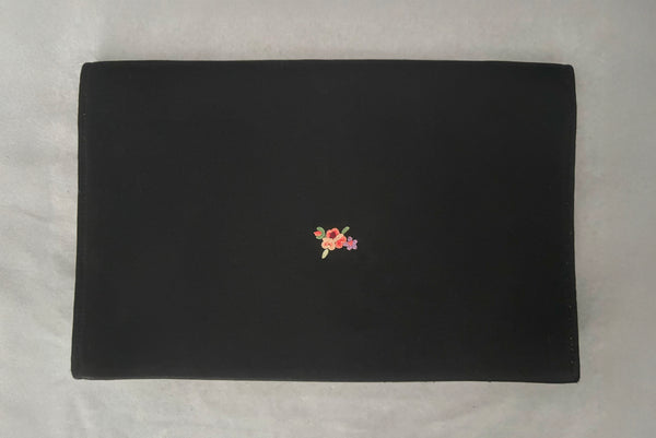 Horizontal back view of 1930s vintage black satin clutch with pink, blue, green, purple, and gold floral chainstitch embroidered clutch by Denis Francet.