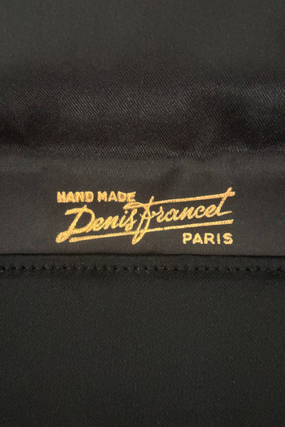 Interior detail view of 1930s vintage black satin clutch with pink, blue, green, purple, and gold floral chainstitch embroidered clutch by Denis Francet. Showing  a close-up of the gold "Hand Made Denis Francet Paris" stamp.