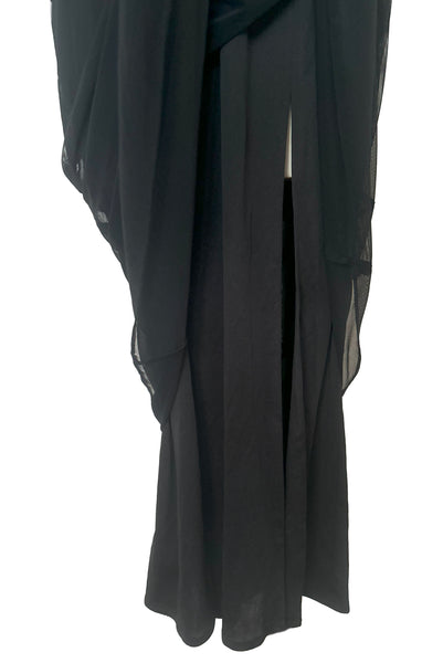 Skirt front view of 1990s vintage Tadashi mockneck black mesh maxi length evening dress, small to medium. Showing the skirt lining with an off center slit.