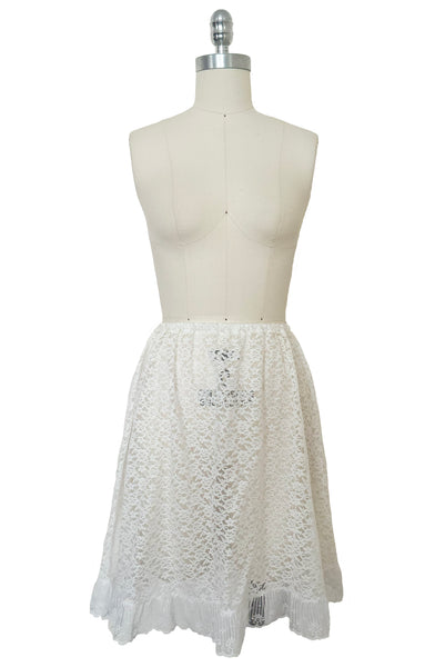 Front view of 1990s vintage sheer white floral lace elastic waist skirt, extra small to medium.