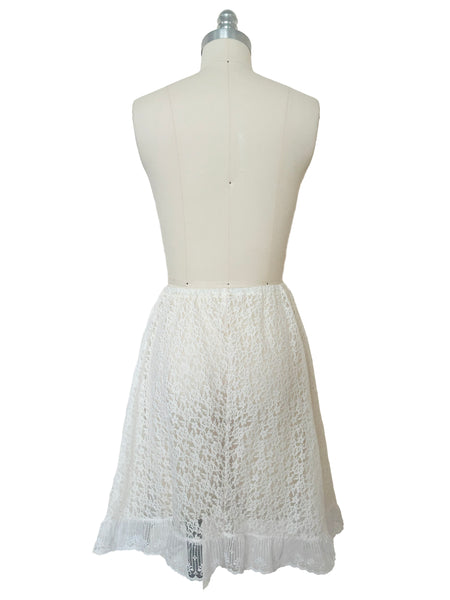 Back view of 1990s vintage sheer white floral lace elastic waist skirt, extra small to medium.