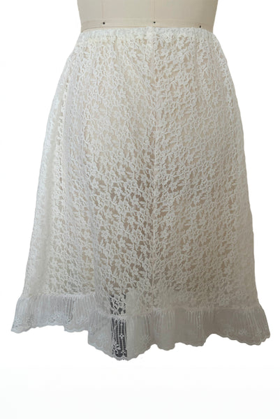 Back view of 1990s vintage sheer white floral lace elastic waist skirt, extra small to medium.