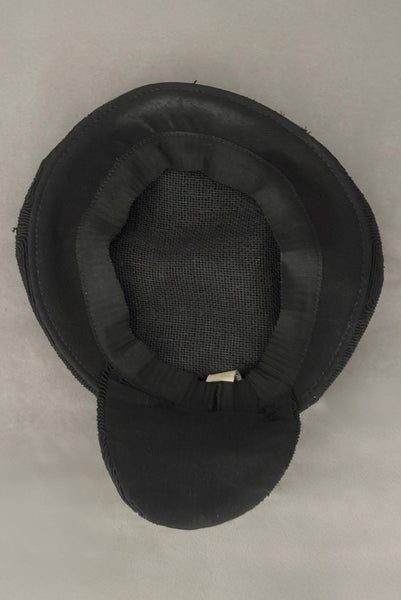 Interior detail view of 1940s vintage black diamond checkboard cordé tilt topper hat. Showing the petersham band and discolored area where the hat rests on the forehead.