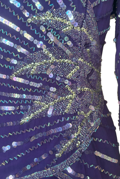 Side top detail view of 1980s vintage beaded purple silk & rayon blouse and drop waist dress Set by Nite Line, small to medium. Showing the iridescent purple sequins and glass beading.