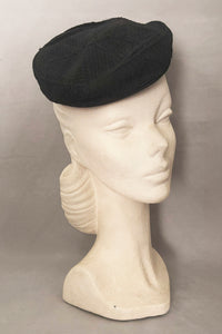 Vertical 3/4 view of 1940s vintage black diamond checkboard cordé tilt topper hat.