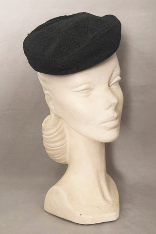 Vertical 3/4 view of 1940s vintage black diamond checkboard cordé tilt topper hat.