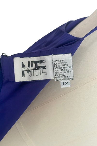 Interior dress detail view of 1980s vintage beaded purple silk & rayon blouse and drop waist dress Set by Nite Line, small to medium. Showing the Nite Line label, fabric composition and size 12 tag.