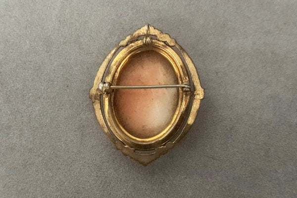 Horizontal back view of 1920s vintage pink and white carved shell women's head figural carved cameo brooch pendant in 12k gold fill setting.