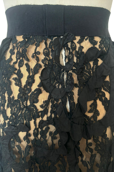 Front detail view of 1990s vintage goth sheer black lace and taffeta nude look skirt, medium to large. Showing the snap closure that snaps the taffeta scallops across the opening.