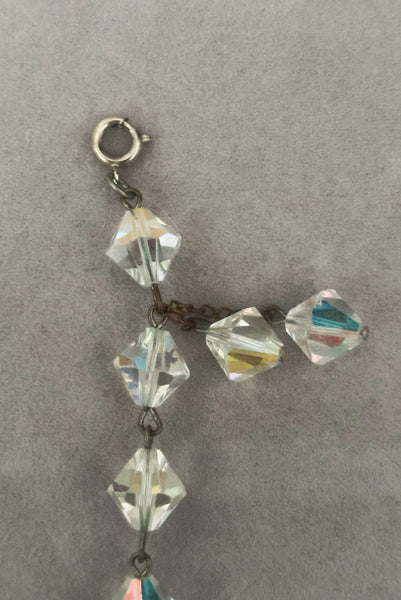 Detail view of 1960s vintage iridescent crystal bicone bead and silver tone bracelet. Showing a cloe-up of the iridescent bicone crystal double bead drop.
