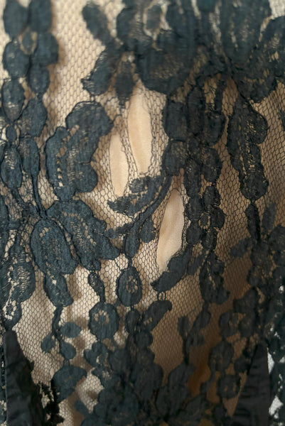 Detail view of 1990s vintage goth sheer black lace and taffeta nude look skirt, medium to large. Showing the black silk taffeta scalloped swirls on the embellished lace, and small breaks in the lace netting.