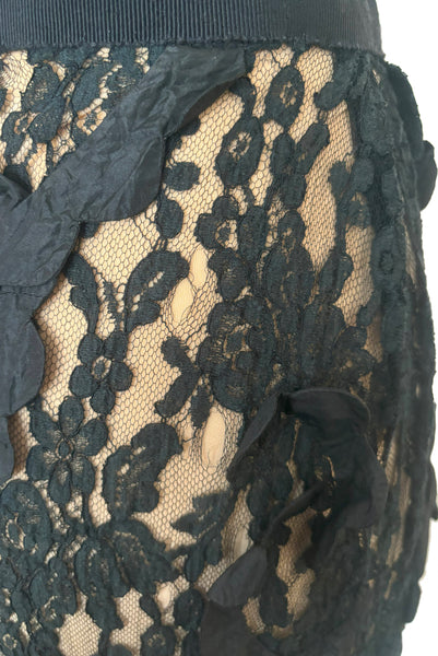 Detail view of 1990s vintage goth sheer black lace and taffeta nude look skirt, medium to large. Showing the black silk taffeta scalloped swirls on the embellished lace, and small breaks in the lace netting.