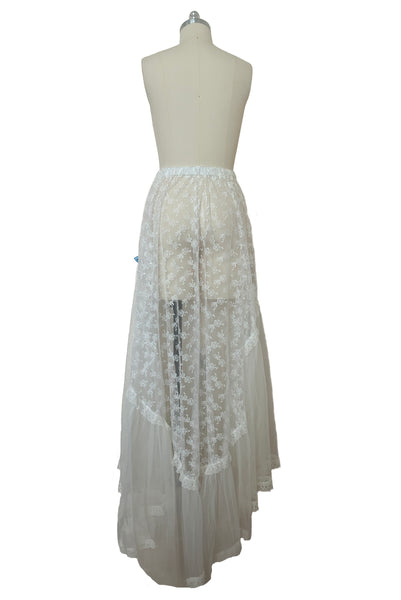 Back view of 1980s vintage sheer white lace & tulle skirt with train, trimmed with blue satin ribbon bows, small, medium, large.