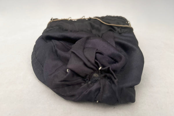 Horizontal interior view of 1910s turn of the century vintage Edwardian silver gray beaded black crochet drawstring handbag. Showing the satin lining.