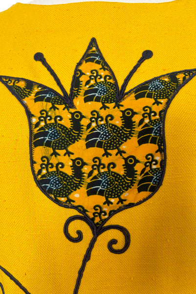 Bodice detail view of 1960s vintage mustard yellow silk suiting shift dress with navy blue, white, & yellow tulip appliques and embroidery by Crazy Horse, small to medium. Showing a large tulip applique in a bird print.