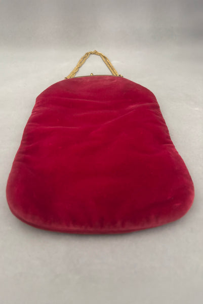 Vertical back perspective view of 1960s vintage rose pink velvet evening handbag with gold frame and chain handle, by Morris Moskowitz.