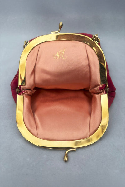 Vertical open view of 1960s vintage rose pink velvet evening handbag with gold frame and chain handle, by Morris Moskowitz.
