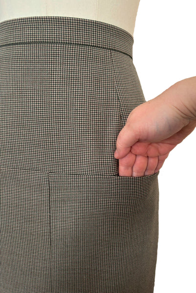 Detail view of 1990s brown, green, and white wool houndstooth pegged pencil skirt with inseam pockets by Chaiken and Capone, small to medium, showing detailing on the horizontal inseam pockets.