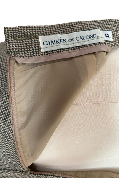 Label view of 1990s brown, green, and white wool houndstooth pegged pencil skirt with inseam pockets by Chaiken and Capone, small to medium. Tagged size 6.