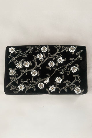 Vertical front view of 1950s vintage black velvet floral silver and white glass and faux cream pearl beaded clutch evening bag.