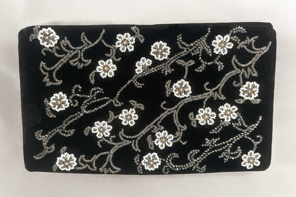 Horizontal front view of 1950s vintage black velvet floral silver and white glass and faux cream pearl beaded clutch evening bag.