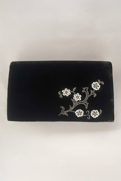 Vertical back view of 1950s vintage black velvet floral silver and white glass and faux cream pearl beaded clutch evening bag.