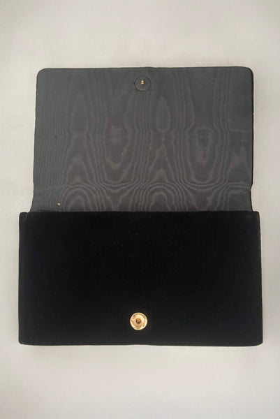 Vertical open view of 1950s vintage black velvet floral silver and white glass and faux cream pearl beaded clutch evening bag. Showing a small hole in the moiré lining.
