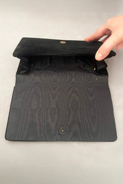 Interior detail view of 1950s vintage black velvet floral silver and white glass and faux cream pearl beaded clutch evening bag. Showing the interior of the clutch with a small hole in the lining and some wear to the edges.