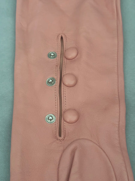 Detail view of 2000s y2k vintage pink leather unlined opera gloves with snap wrists, by J.Crew, size L. Showing the matching leather covered snaps at the inner wrist.