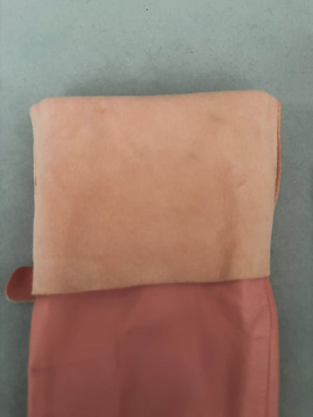 Interior detail view of 2000s y2k vintage pink leather unlined opera gloves with snap wrists, by J.Crew, size L. Showing the unlined interior.