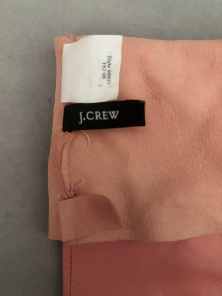 Interior detail view of 2000s y2k vintage pink leather unlined opera gloves with snap wrists, by J.Crew, size L. Showing the J.Crew label.