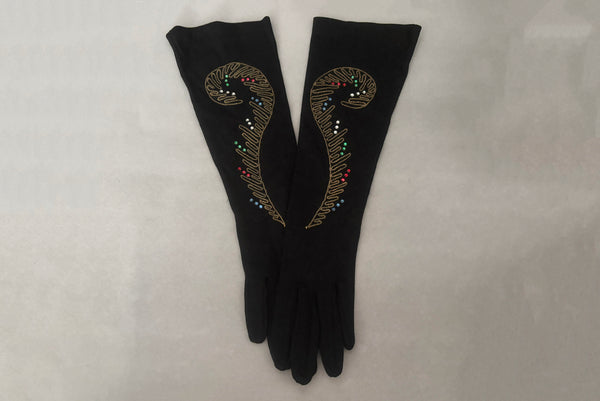 Horizontal pair view of 1950s vintage black mid length gloves with clear, red, blue, & green prong set rhinestone and gold work embroidery by Lady Gay, size 7.