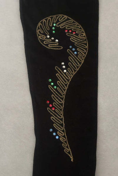 Detail view of 1950s vintage black mid length gloves with clear, red, blue, & green prong set rhinestone and gold work embroidery by Lady Gay, size 7. Showing a close-up of the curling fern frond gold metal embroidery with surrounding rhinestones.