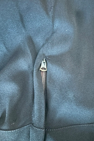 Side detail view of 1930s vintage black rayon crepe evening gown with statement sleeves beaded with glass beads and brass sequins, small to medium. Showing the Art Deco tab metal zipper.