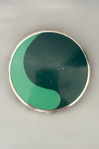 Vertical top view of 1930s vintage Art Deco two tone green and silver tone chrome compact.